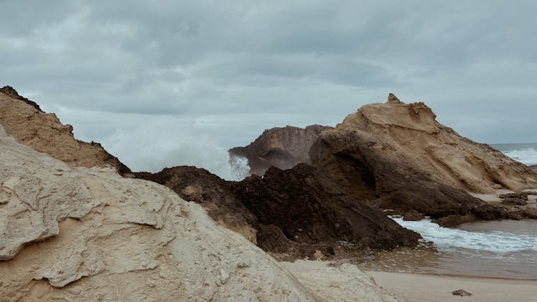 View of Waves Crashing on Rock Formations on a Shore