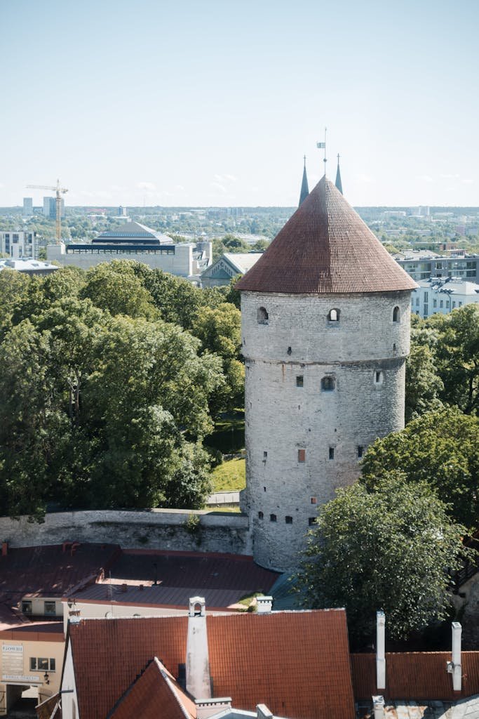 Historic Kiek in de Kök tower in Tallinn, Estonia, with lush greenery surrounding it.